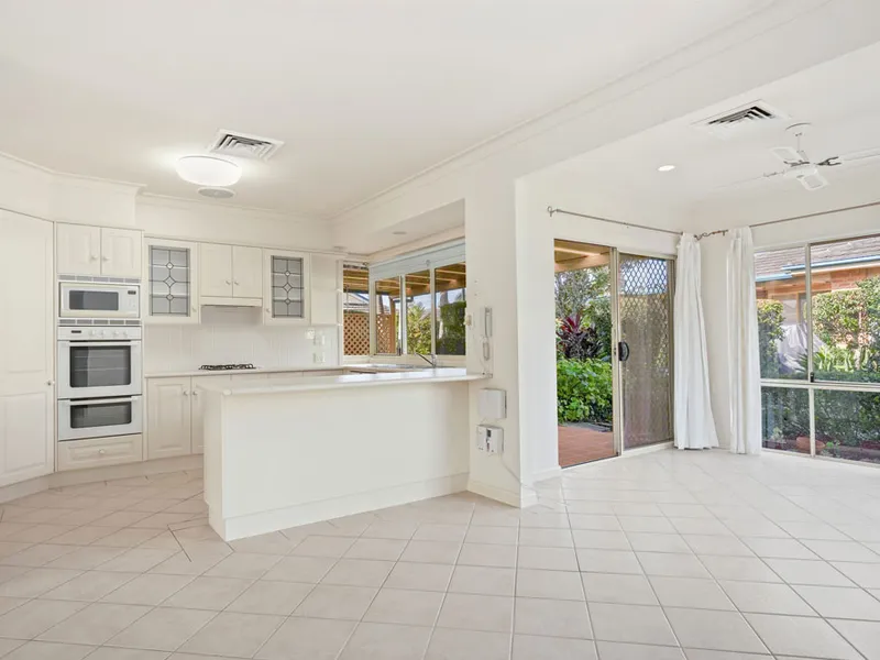 Open plan living with enclosed sunroom overlook private garden area