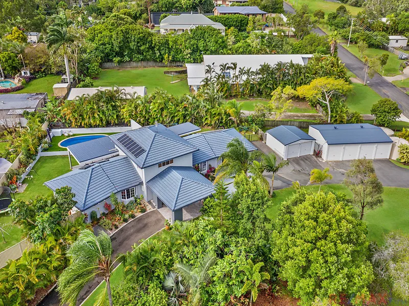 LUSH ACREAGE WITH DUAL LIVING & SHEDS!