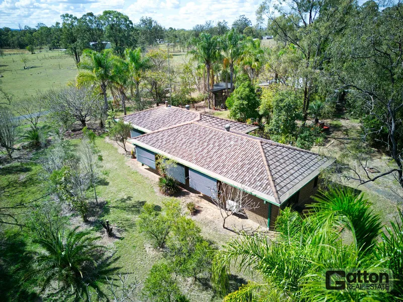 EXPANSIVE 10-ACRE RETREAT WITH ENCHANTING GARDENS & VERSATILE SHEDS