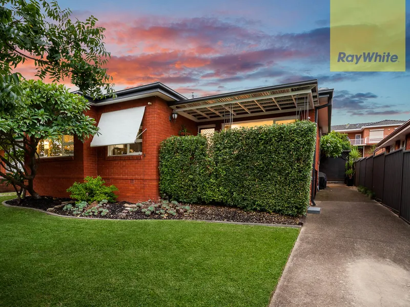 STYLISH BRICK HOME ON MANICURED PROPERTY