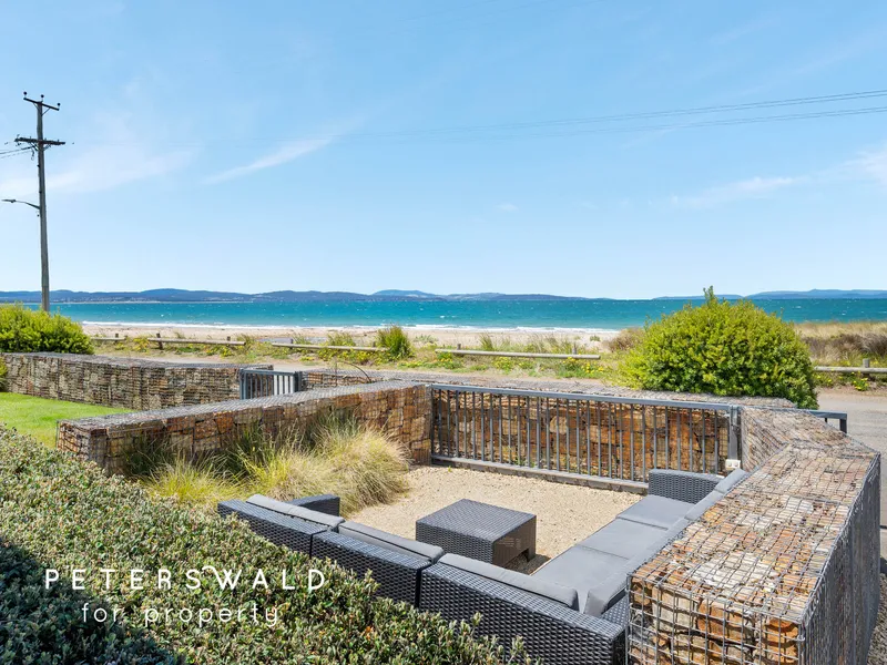 Luxury beachside living from contemporary coastal Seven Mile Beach haven