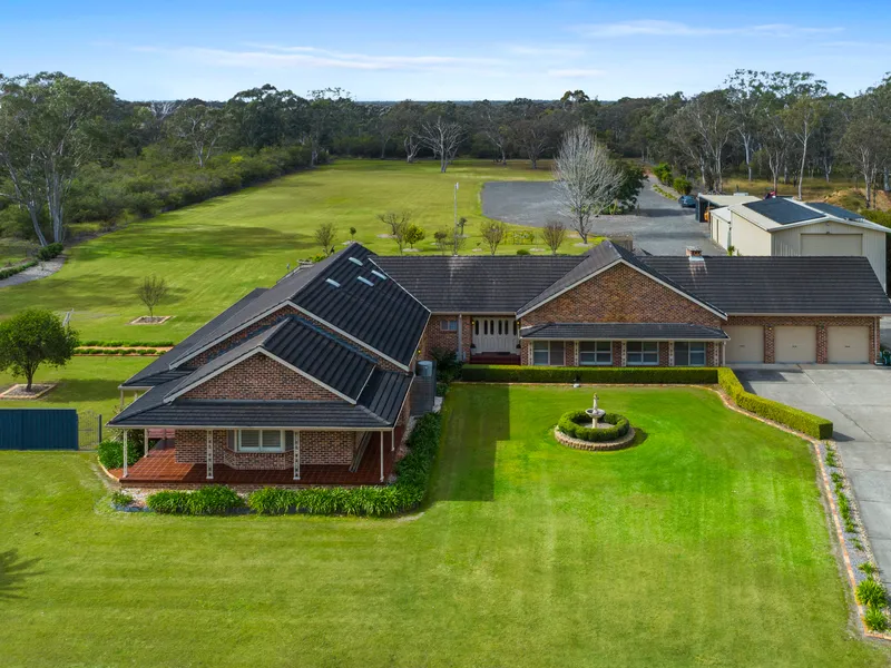 Immaculate Acreage Homestead with Ample Shedding