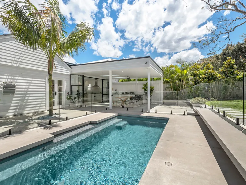 Designer beach house on sunny resort-like gardens