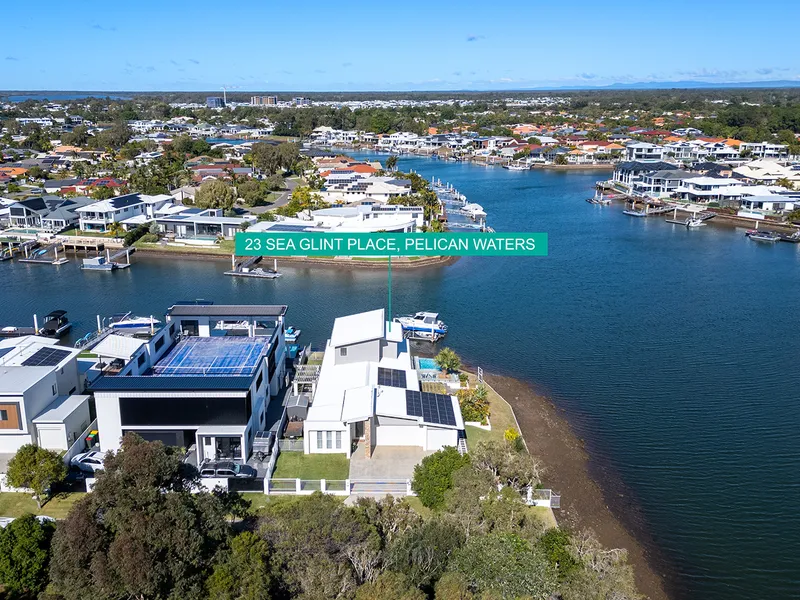 A Grand Waterfront Home Positioned On A Corner Block With Far Reaching Views Of Pelican Waters Main Canal