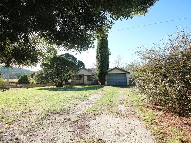 Renovation opportunity on 1.5 acres close to town
