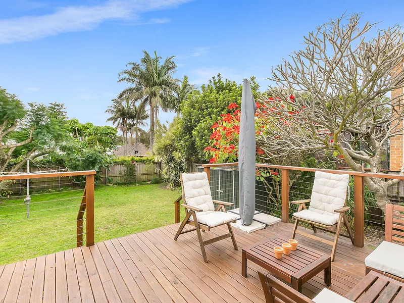 BEACHSIDE HOME SURROUNDED BY LUSH LEVEL LAWN IN PREMIERE LOCALE