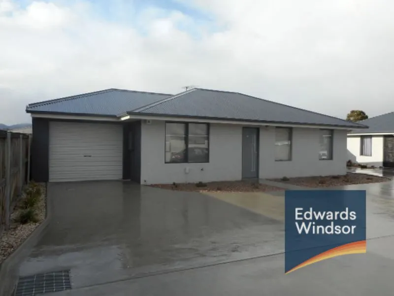 Villa unit with garage and small fenced yard