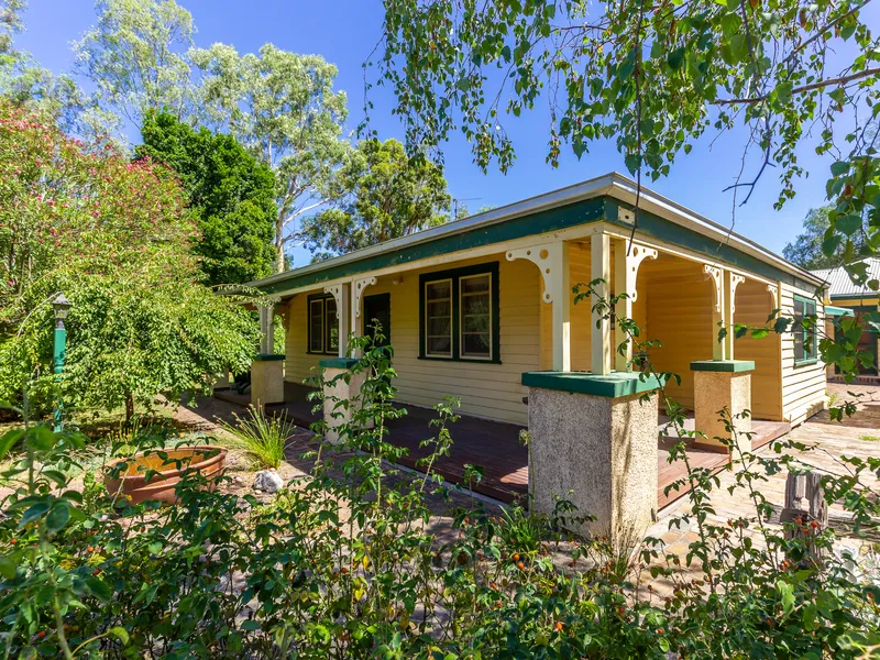 A COUNTRY HOMESTEAD NESTLED IN A PICTURESQUE GARDEN SETTING