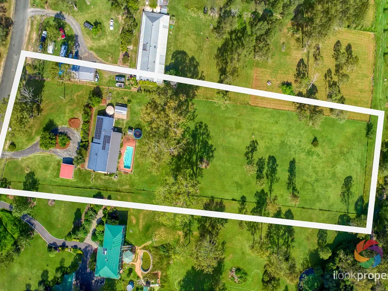 OVER TWO ACRES OF YOUR OWN PRIVATE ACREAGE PARADISE