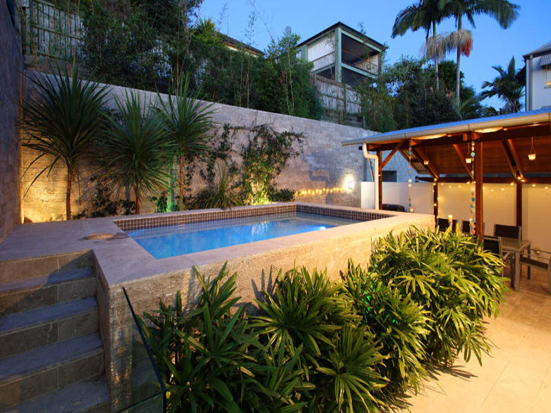 In-ground pool design using pavers with gazebo & decorative lighting ...